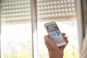 Man in a Weehawken, NJ Home Controlling his Smart Home Blinds from an iPhone