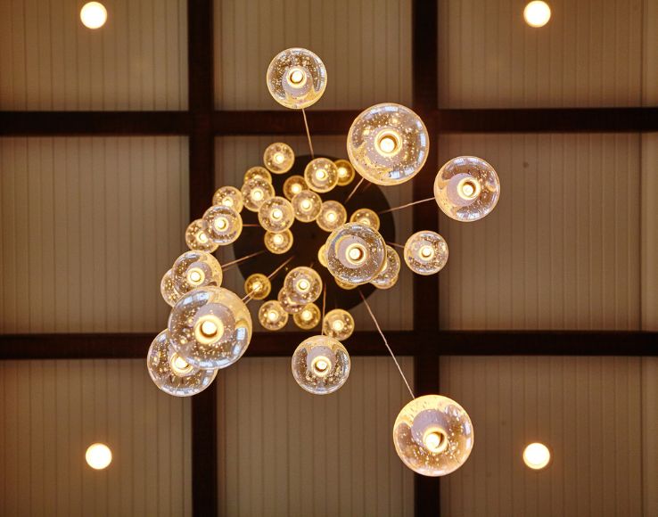 Architectural lighting design with a cascading orb chandelier in Franklin Lakes