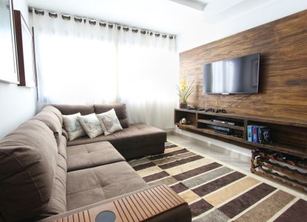 Whole home audio with a wall-mounted TV on a wood feature wall in Montclair