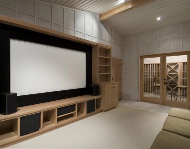 Home theater design with a projection screen and built-in cabinetry in Mendham