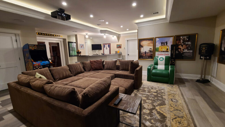 Basement lounge home theater with a ceiling projector and sectional for a home theater installation in Short Hills