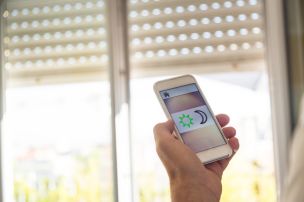 Controlling smart home blinds from a phone app by a window in Edgewater