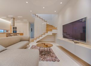 Open-plan living room with a large wall-mounted TV for smart homes in Montclair