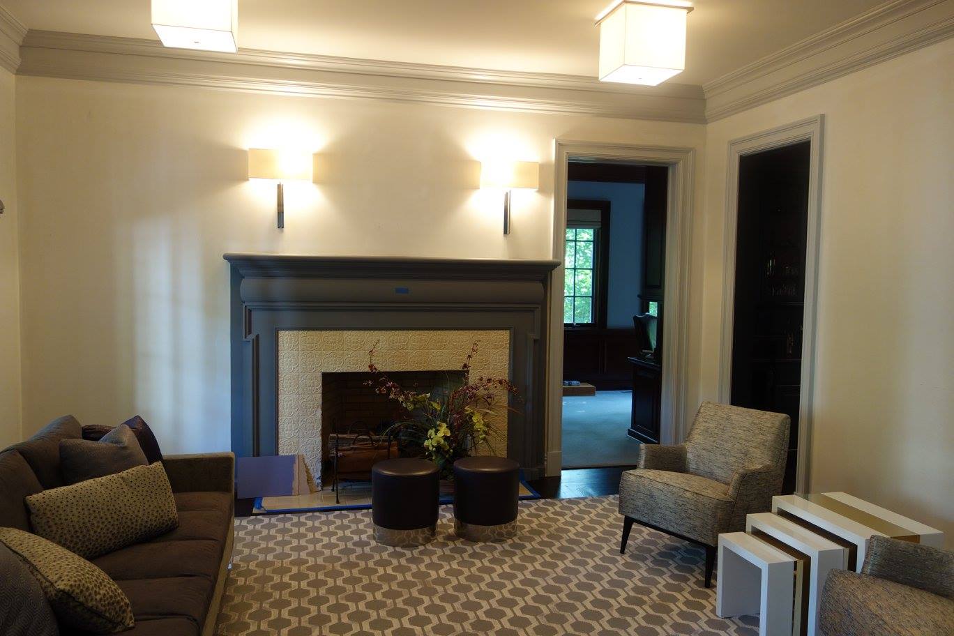 Living room with a slim TV over the fireplace and architectural lighting design in Alpine