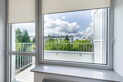 Electric blinds on bright living room windows in Franklin Lakes