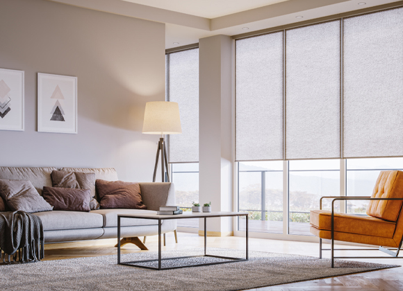 Automatic blinds as roller shades on tall living room windows in New City