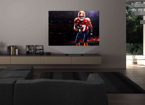 Living room with a large wall-mounted TV and one of the best home theater systems in Ho-Ho-Kus