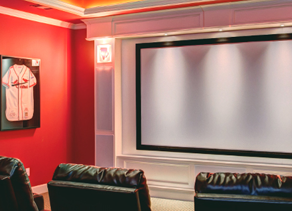 Red-walled home theater with a large screen and leather recliners for a home theater installation in Short Hills