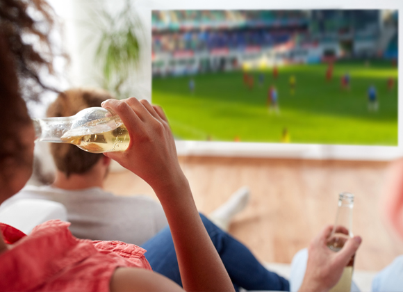 Watching a soccer match on a large TV with one of the best home theater systems in Mahwah