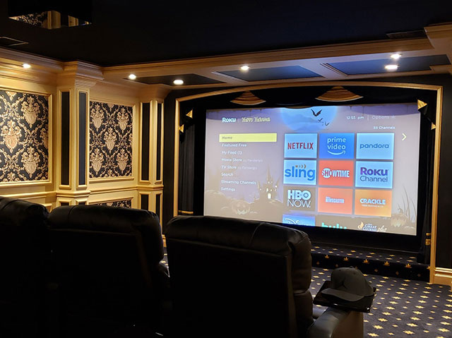 Ornate home theater with a large screen showing streaming apps for a home theater installation in New City