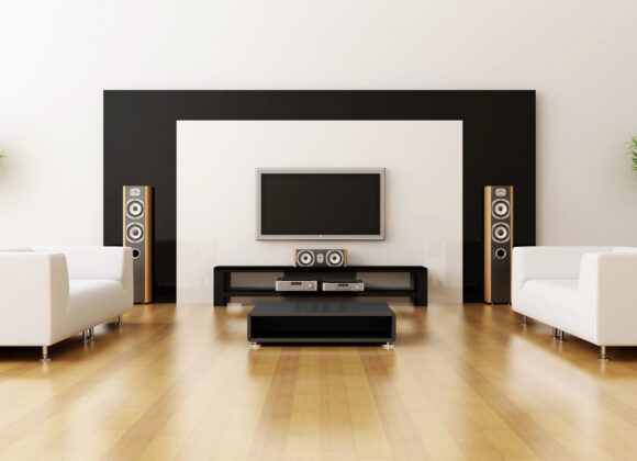 Whole home audio with a wall TV and floor-standing speakers in a Fort Lee living room