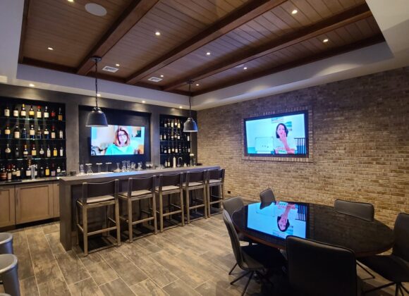 Smart home automation in a basement bar lounge with wall displays in Englewood Cliffs