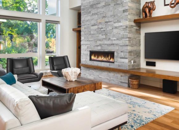 Open-concept living room with a wall-mounted TV and whole home audio in Ridgewood