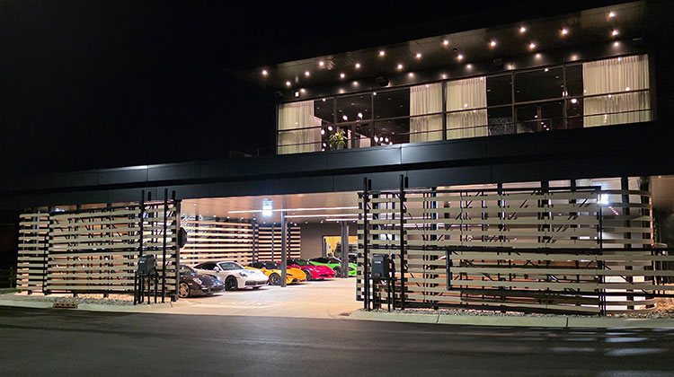 Luxury car club building at night with a commercial A/V installation in Ho-Ho-Kus