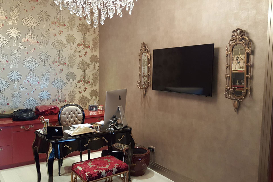 Home office with a wall-mounted TV and elegant decor for a home A/V installation in Upper East Side