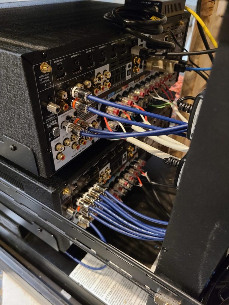 Rear of an AV receiver with organized cabling for a home A/V installation in Ridgewood