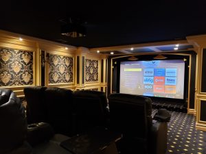 Luxury home cinema design with a projection screen and leather recliners in Alpine