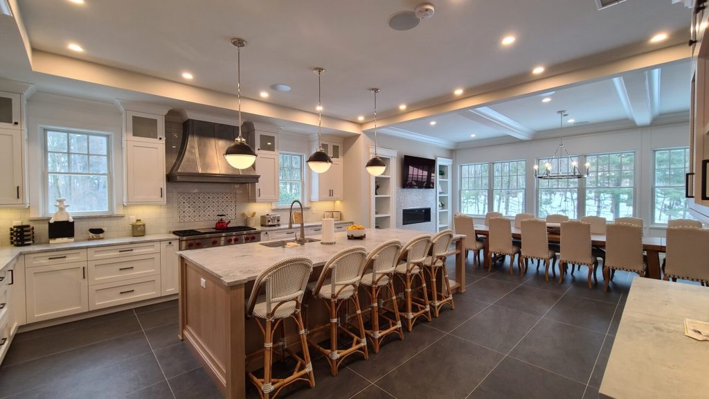 Open kitchen and dining area with smart home lighting and whole home audio in Saddle River