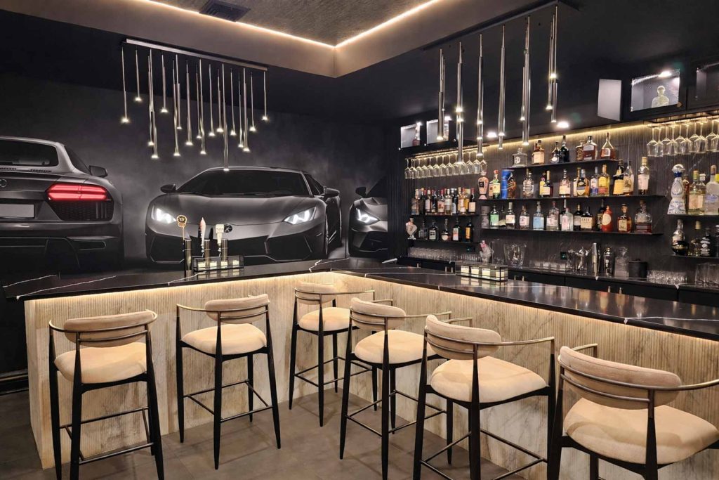 Luxury home bar with architectural lighting and a backlit display in Alpine