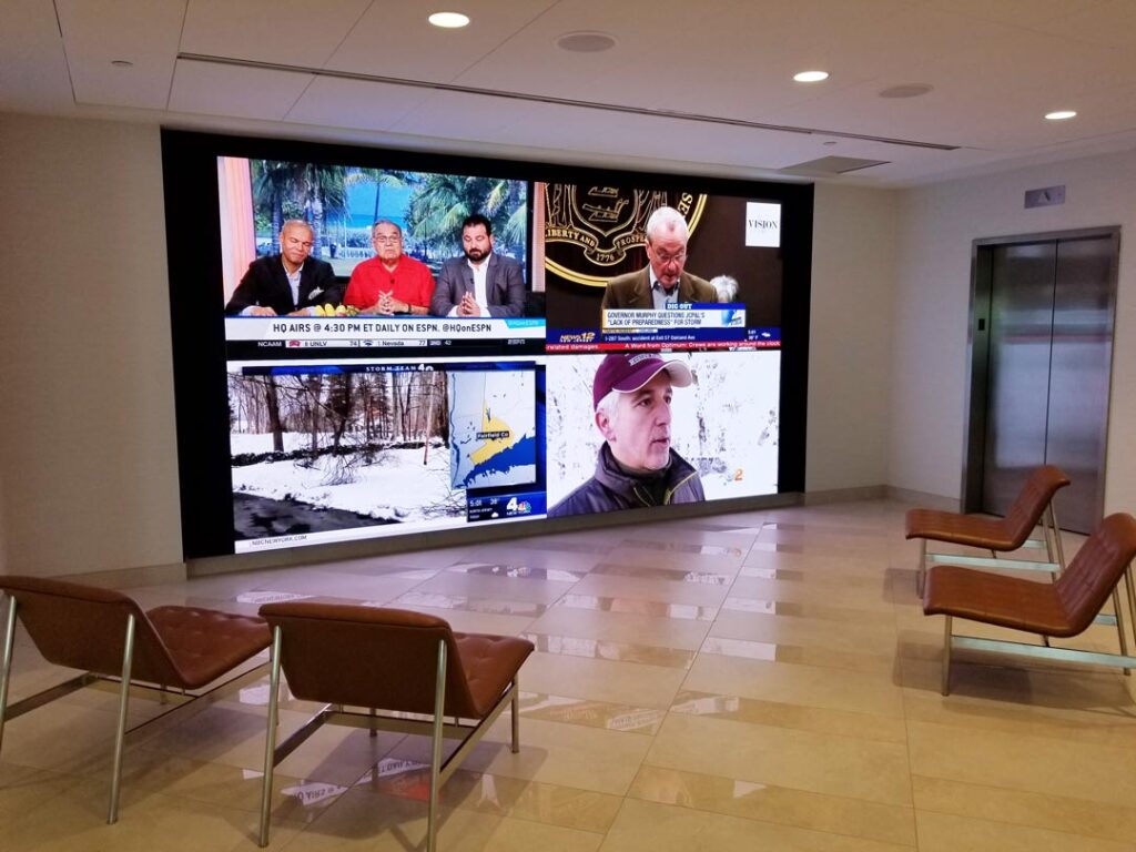 Commercial video wall displaying live broadcasts in an office lobby in Montclair