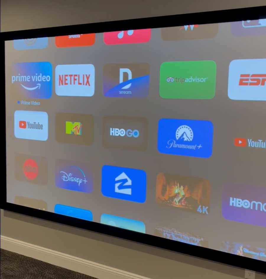 Home theater projection screen showing streaming apps for home cinema design in Saddle River