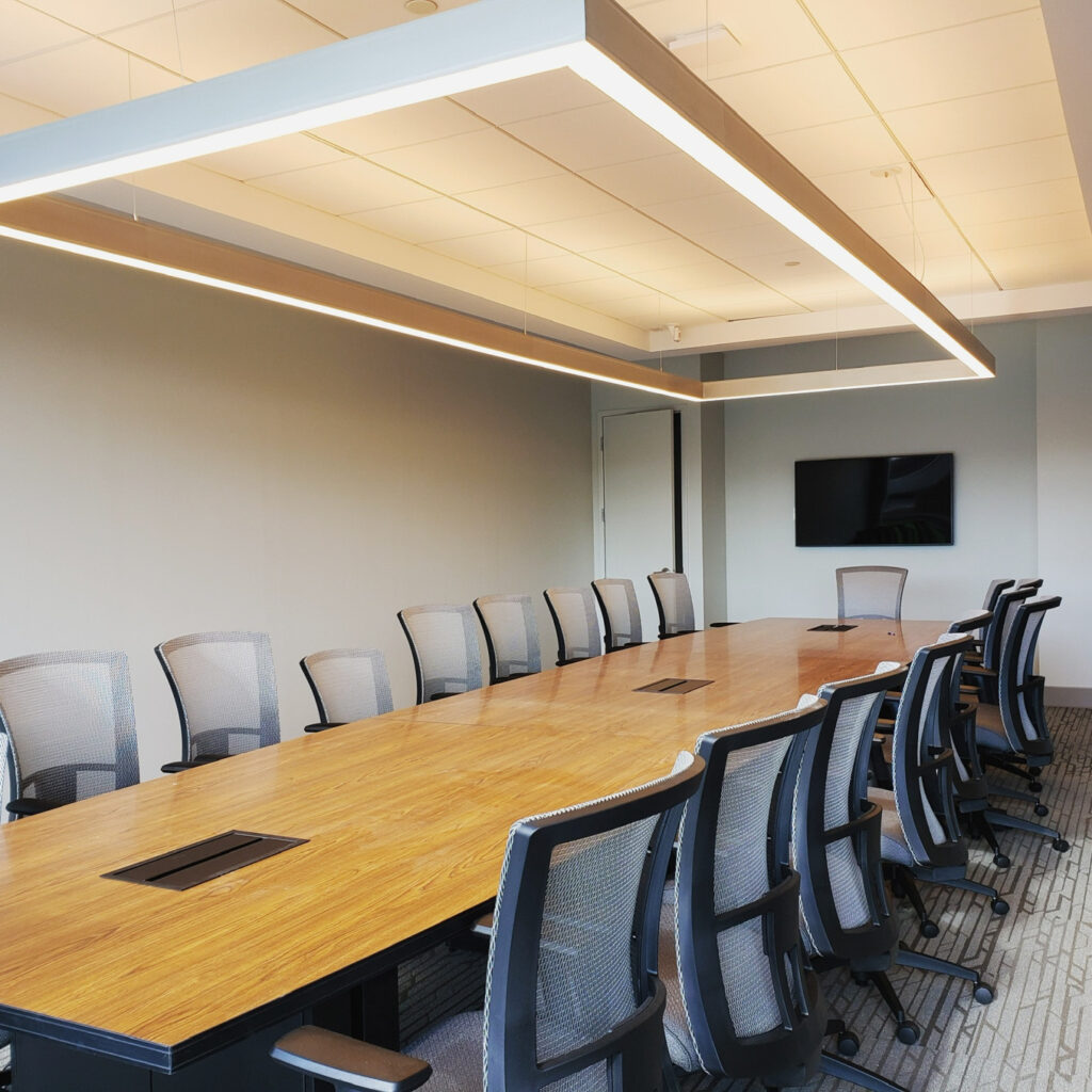 Corporate boardroom with commercial AV, a wall-mounted display, and architectural lighting in Upper West Side